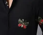 black tee embroidered with butterfly images